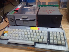 The UK-spec D model with the cover off, showing the power supply, the disk drive and the hard disk.